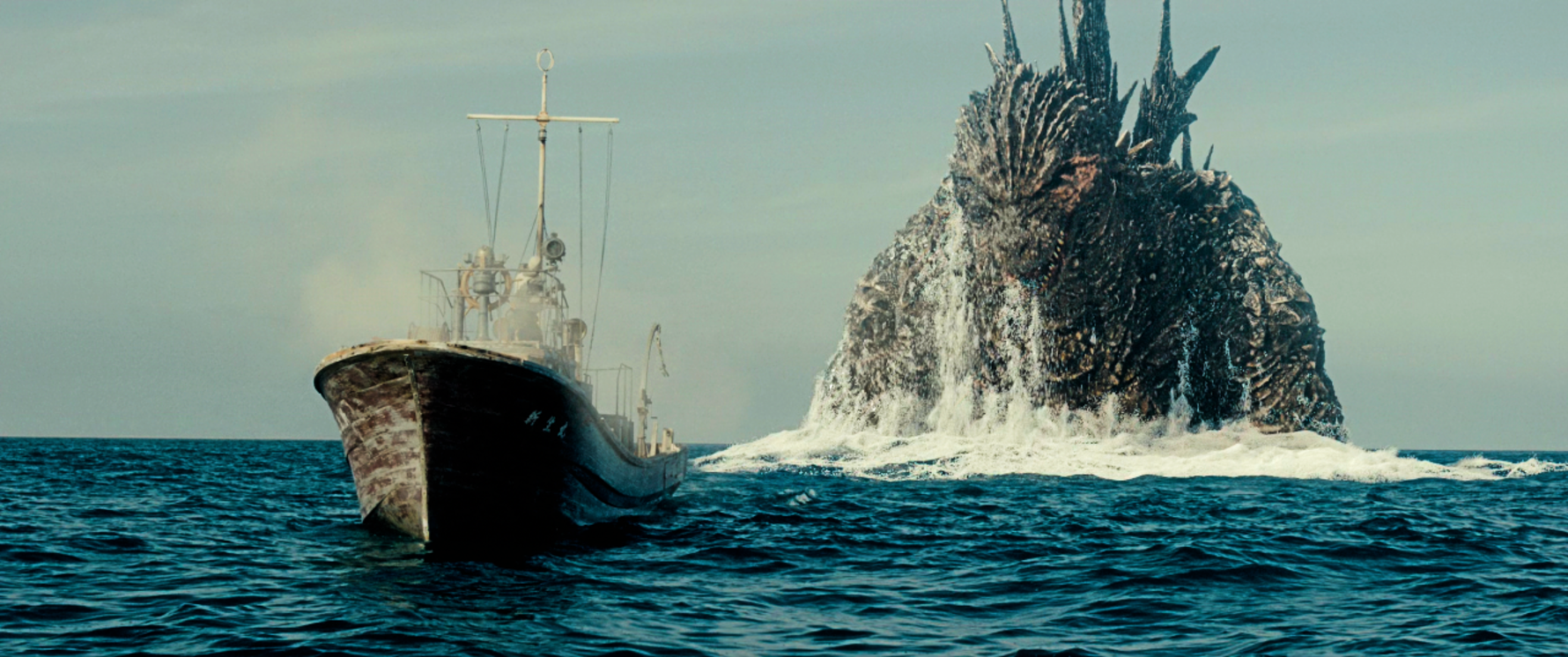 Godzilla emerges in front of a frightened crew in Godzilla Minus One